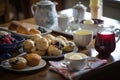 breakfast table, filled with muffins and scones, and tea cup for 2 Royalty Free Stock Photo