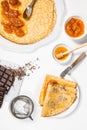 breakfast table with french crepes filled with apricot jam