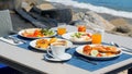 Breakfast table full of food at seaside restaurant, with sea view Royalty Free Stock Photo