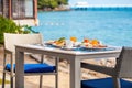 Breakfast table full of food at seaside restaurant, with sea view Royalty Free Stock Photo