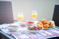 Breakfast on the table, juice, cereal and fruits in the sun. Goo Royalty Free Stock Photo