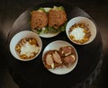 Sandwich, Hamburger and Muesli with banana in white bowl