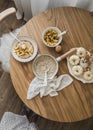 Breakfast table - oatmeal porridge in a saucepan, a plate of porridge and apple cinnamon sauce on a round table, top view Royalty Free Stock Photo