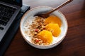 Breakfast on the table oats and oranges and granola