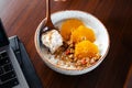 Breakfast on the table oats and oranges and granola