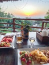 Breakfast table in rustic wooden terace patio of a a restaurant in Zanxibar at sunrise or sunset Royalty Free Stock Photo