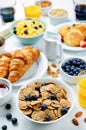 Breakfast table setting with flakes, juice, croissants, pancakes Royalty Free Stock Photo