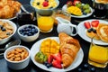 Breakfast table setting with flakes, juice, croissants, pancakes Royalty Free Stock Photo