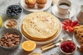 Breakfast table setting with fresh fruits, pancakes, coffee, croissants Royalty Free Stock Photo