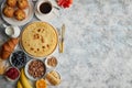Breakfast table setting with fresh fruits, pancakes, coffee, croissants Royalty Free Stock Photo
