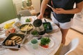 Breakfast table and woman poring coffee.