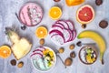 Breakfast table with yogurt strawberry smoothie bowls and fresh tropic fruits on a gray stone background. Acai bowl of Royalty Free Stock Photo