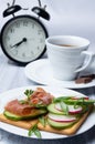 Breakfast with tea and ham and vegetable sandwiches