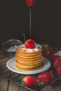 Breakfast Time with Fresh Strawberry on Stack of Pancake Pouring