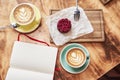 Breakfast time with two cups of fresh coffee from above on wooden background, sweet strawberry cake on wood board, opened book Royalty Free Stock Photo