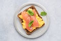 Breakfast toast with scrambled eggs and smoked salmon Lox