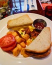 Breakfast with Toasted Bread, Potatos, Scrambled eggs and Tomato Royalty Free Stock Photo