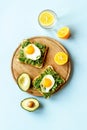 Breakfast with toasts of fried eggs and avocado saurce. Top view Royalty Free Stock Photo