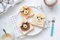 Breakfast toasts with nut butter and banana with cute funny animal face. Kids food Royalty Free Stock Photo