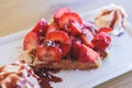 Breakfast with traditional dessert - Belgian waffle with fresh berries, whipped cream and caramel sauce syrup, plate with viennese