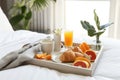 Breakfast Tray Arranged On White Bed