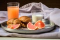 breakfast tray with a bagel, cream cheese, and a glass of grapefruit juice on a minimalist bed Royalty Free Stock Photo