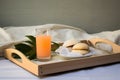 breakfast tray with a bagel, cream cheese, and a glass of grapefruit juice on a minimalist bed Royalty Free Stock Photo