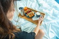 Breakfast on tray in bed for young beautiful funny woman Royalty Free Stock Photo