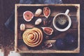 Breakfast tray with black coffee, cinnamon roll, fresh figs and pecans Royalty Free Stock Photo