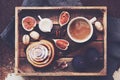 Breakfast tray - cup of coffee with cream, cinnamon roll, fresh figs and pecans Royalty Free Stock Photo
