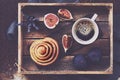 Breakfast tray - cup of espresso, cinnamon bun and fresh figs