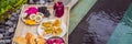 Breakfast on a tray with fruit, buns, avocado sandwiches, smoothie bowl by the pool. Summer healthy diet, vegan Royalty Free Stock Photo