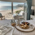 Breakfast tray and magazine on bed overlooking ocean