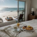 Breakfast tray and magazine on bed overlooking ocean