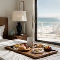 Breakfast tray and magazine on bed overlooking ocean