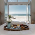 Breakfast tray and magazine on bed overlooking ocean