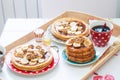 Breakfast tray with pancakes with bananas, maple syrup and nuts, cup of coffee and honey