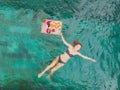 Breakfast tray in swimming pool, floating breakfast in luxury hotel. Girl relaxing in the pool drinking smoothies and