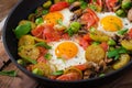 Breakfast for two. Fried eggs with vegetables - shakshuka in a frying pan Royalty Free Stock Photo