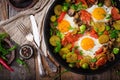 Breakfast for two. Fried eggs with vegetables - shakshuka in a frying pan Royalty Free Stock Photo