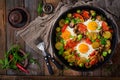 Breakfast for two. Fried eggs with vegetables - shakshuka in a frying pan Royalty Free Stock Photo