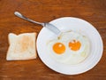 Breakfast with two fried eggs in white plate Royalty Free Stock Photo