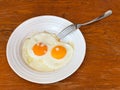 Breakfast with two fried eggs in white plate Royalty Free Stock Photo