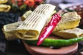 Breakfast two spicy delicious burritos mexican fast food dinner on wooden board wood table decorated with red and green hot pepper Royalty Free Stock Photo