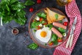 Breakfast on Valentine`s Day - fried eggs in the shape heart, sausage, toast and caprese salad Royalty Free Stock Photo