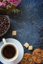 Breakfast in vintage style. A cup of coffee with pieces of cane sugar, biscuits with chocolate and a vase with coffee beans. Top Royalty Free Stock Photo