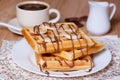 Breakfast waffles with bananas, chocolate syrup and coffee