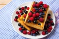 Breakfast waffles with fresh berries on the blue linen napkin Royalty Free Stock Photo