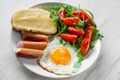 Breakfast which includes eggs, sausages, salad and toast