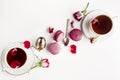 Breakfast on white table with roses and macarons. Vallentines day, womens day and romance concept. Flat lay, top down. Copy